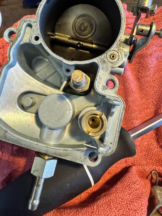 IMG_3043 Looking straight into wide-slotted brass fuel inlet valve seat on upper air horn next to brass vacuum piston